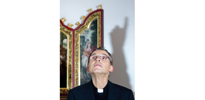 This file picture shows Tebartz-van Elst being directed by a photographer during a photo shoot.