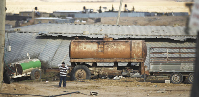 A boy stands in front of a shed in the Bedouin village of Bir Mshash on Tuesday.