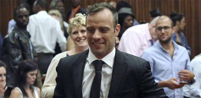Oscar Pistorius reacts after he was granted bail as he leaves the North Gauteng High Court in Pretoria