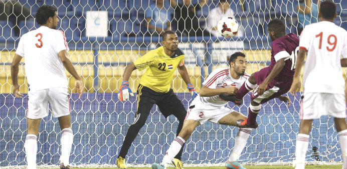 Khalfan Ibrahim scores with a header for Qatar in their Asian Cup qualifier against Yemen yesterday.