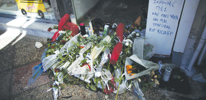 Floral tributes are laid at the spot in Piraeus where Pavlos Fyssas was murdered on Wednesday.