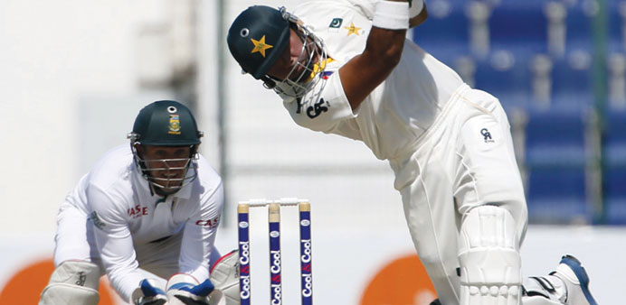 Khurram Manzoor lofts one over the infield in Abu Dhabi yesterday.