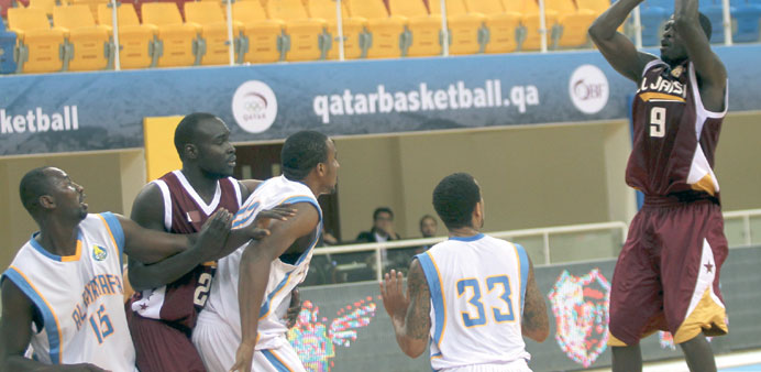 El Jaishu2019s Turki Ali (right) scores against Al Gharafa during their HH the Emir Cup match yesterday. PICTURE: Osman al-Samarrai