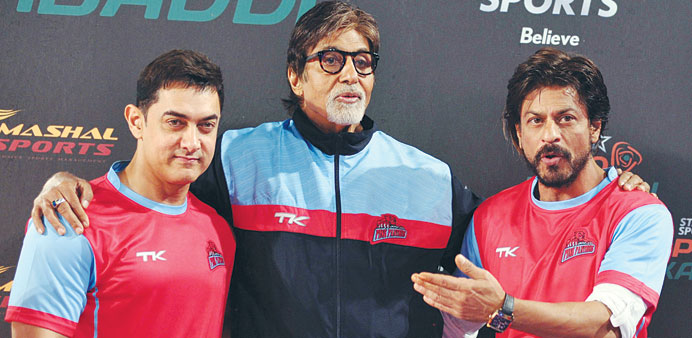 Bollywood actors Aamir Khan, Amitabh Bachchan and Shah Rukh Khan pose for a photograph during a professional kabaddi league match in Mumbai on Saturda