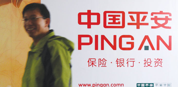 Pedestrians walk past a Ping An Insurance (Group) advertisement in Beijing, China (file). China has approved the sale of HSBCu2019s remaining $7.4bn stake