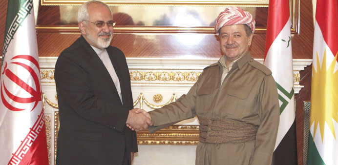  Barzani shakes hands with Zarif in Arbil yesterday.
