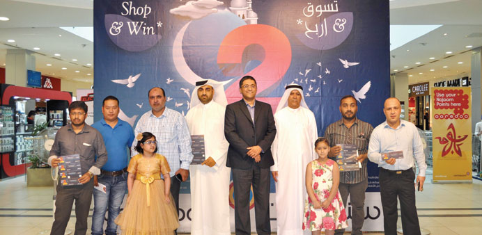 Landmark Group Qatar COO Santosh Pai joins some of the winners during the awarding ceremony.