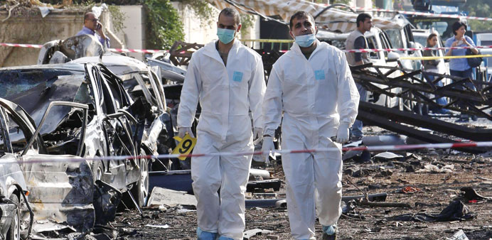 Forensic experts work at the site of the bomb attack.