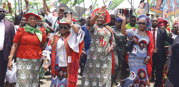 Patience Jonathan (second left), the wife of Nigerian President and ruling Peopleu2019s Democratic Party presidential candidate Goodluck Jonathan, waves a