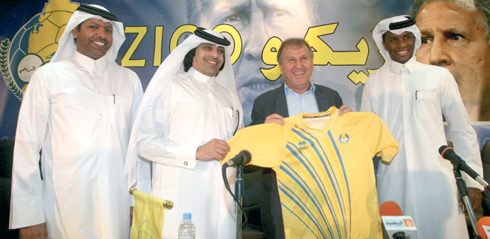 Al Gharafa officials pose with Zico after the Brazilian signed a two-year deal to coach the club yesterday.