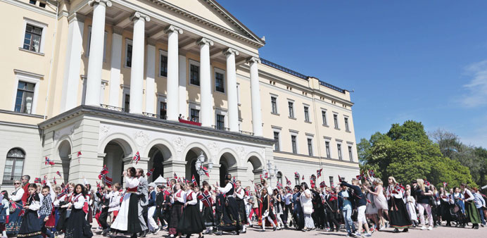 Children parade in front of the Royal Palace during the celebration of the Norwegian Constitution Day in Oslo.