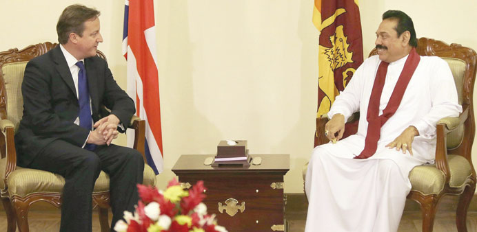 Britainu2019s Prime Minister David Cameron, left, speaks to Sri Lankau2019s President Mahinda Rajapakse during their meeting in Colombo yesterday. 