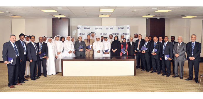 The honoured staff with officials.