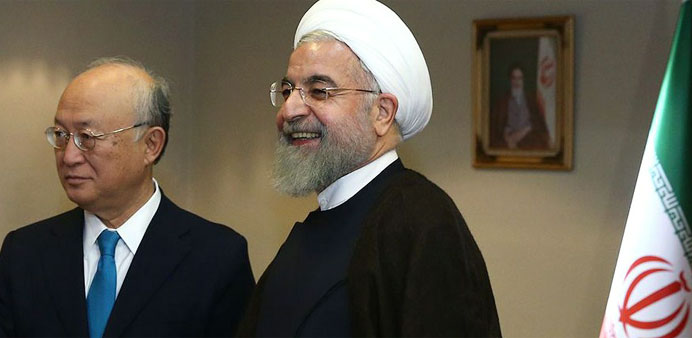 Iranian President Hassan Rouhani (R) with the head of the UN's atomic watchdog Yukiya Amano