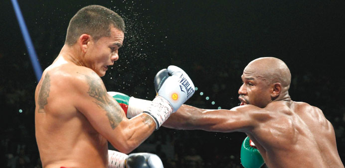 Floyd Mayweather Jr. (right) of the US punches Marcos Maidana of Argentina during their title fight.