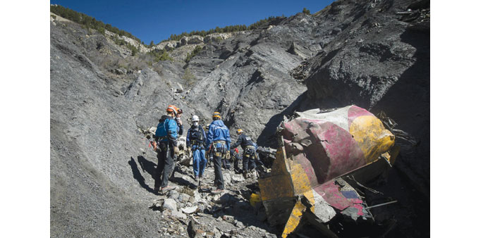 Investigators work near debris from wreckage at the crash site of a Germanwings Airbus A320, near Seyne-les-Alpes.