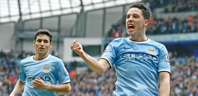 Manchester Cityu2019s midfielder Samir Nasri (right) celebrates scoring their second goal during the EPL match against Southampton at the Etihad Stadium i