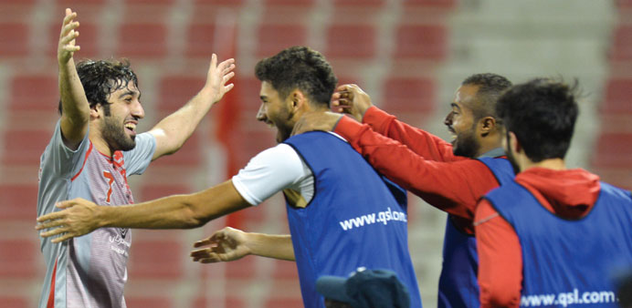  Lekhwiya's Khaled Muftah (left) celebrates his goal against Al Arabi with teammates. PICTURE: Noushad Thekkayil