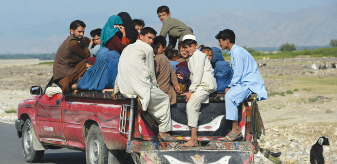 Afghans flee their homes during ongoing clashes between Afghan security forces and militants in Kot district of Nangarhar province yesterday.