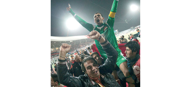 Iraqu2019s Younis Mahmood celebrates after winning their Gulf Cup semi-final against Bahrain 4-2 on penalties in Isa Town, yesterday. (Reuters)
