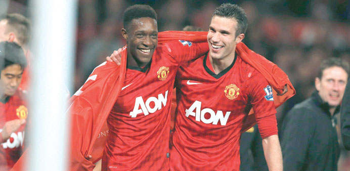Manchester Unitedu2019s Robin van Persie (right) celebrates with Danny Welbeck after his team clinched the English Premier League soccer title.