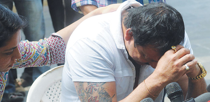 Sanjay Dutt is comforted by his sister and Congress MP Priya Dutt as he breaks down during a media conference outside his residence in Mumbai yesterda