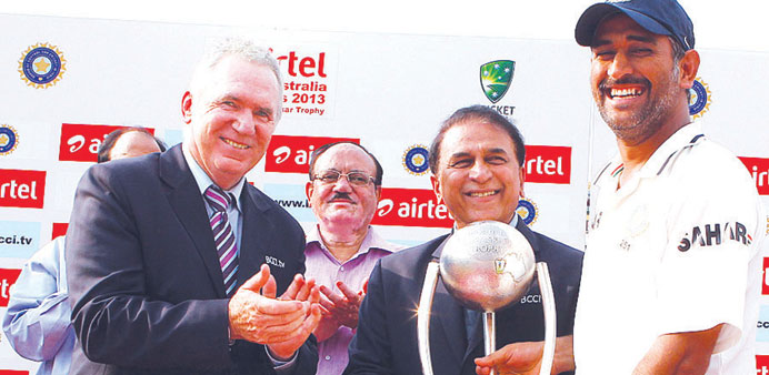 Allan Border (left) and Sunil Gavaskar (second from right) present the Border-Gavaskar trophy to MS Dhoni in New Delhi yesterday.