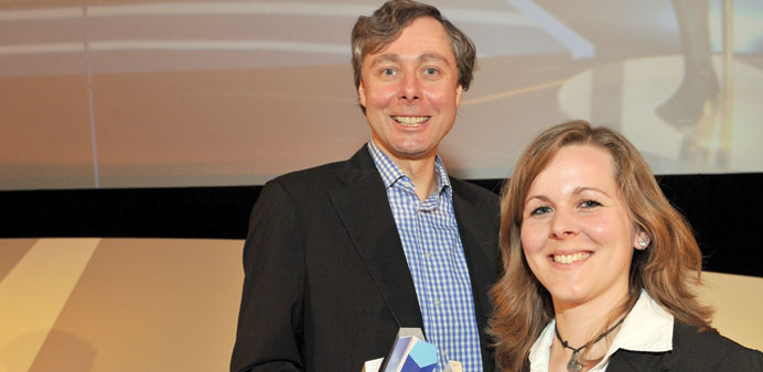 * Ralph Stock (left) and Judith Grave (right) of Serious Games Solutions with their computer-game prize in Berlin.