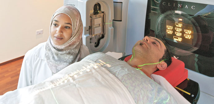 A radiologist is seen with a patient during an examination.