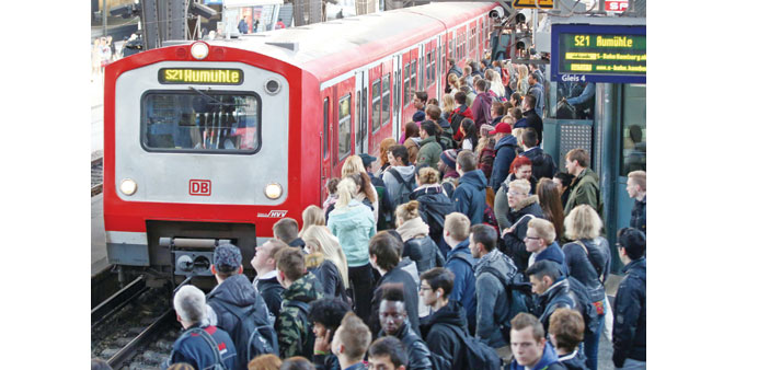  Train passengers crowd in front of a commuter train at the central railway station in Hamburg yesterday.