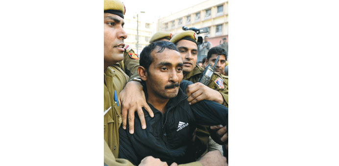 In this photograph taken on December 8, 2014, police escort Uber taxi driver Shiv Kumar Yadav following his court appearance in New Delhi.