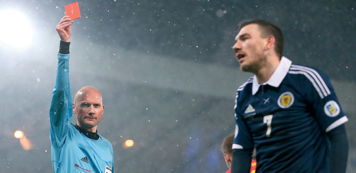 Referee Anthony Gautier of France shows Scotlandu2019s Robert Snodgrass the red card during the Group A FIFA World Cup 2014 Qualifying match against Wales