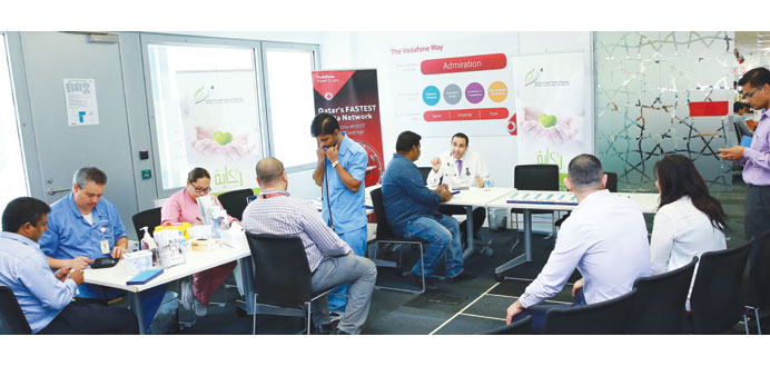 A PHCC team interacts with Vodafone Qatar employees.