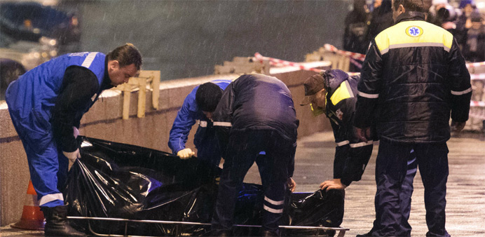 Medics lift the body of Russian opposition leader Boris Nemtsov, covered with plasti