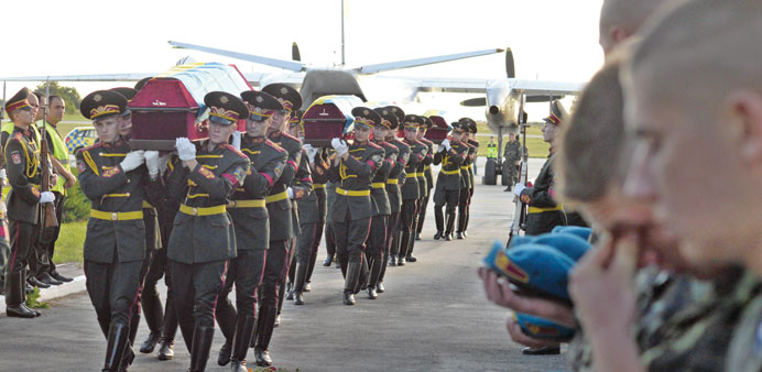Soldiers carry coffins with bodies of 11 Ukrainian servicemen at the airport of Lviv, who died during anti-terrorists operation in eastern Ukraine.
