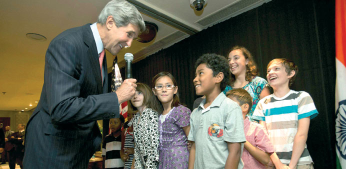 US Secretary of State John Kerry greets children during a meet-and-greet with staff and families from the US embassy in New Delhi.