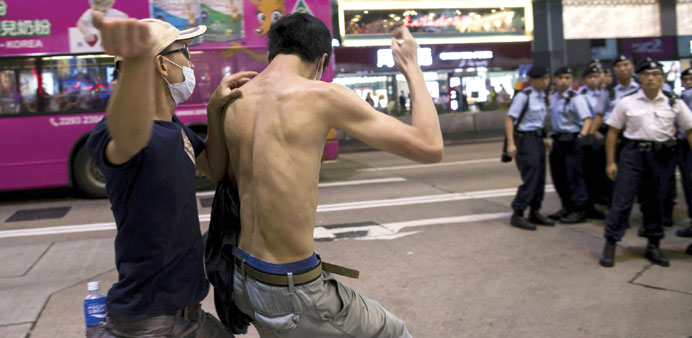 A local protester scuffles with a pro-China demonstrator during an anti-China protest at Mongkok shopping district in Hong Kong on Sunday.