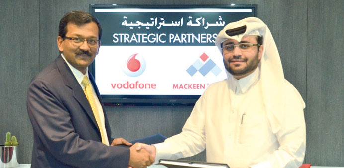 Kaldari (right) and Singh shake hands following the agreement signing.