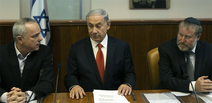 Israeli Prime Minister Benjamin Netanyahu (C), flanked by Minister of Intelligence Yuval Steinitz (L) and Cabinet Secretary Avichai Mendelblit