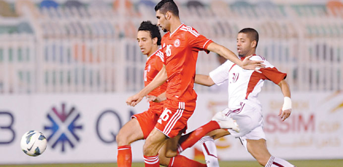 Al Arabi (in Red) and Markhiya players vying for the ball during their Sheikh Jassim Cup match in Doha on Wednesday. PICTURE: Jayan Orma