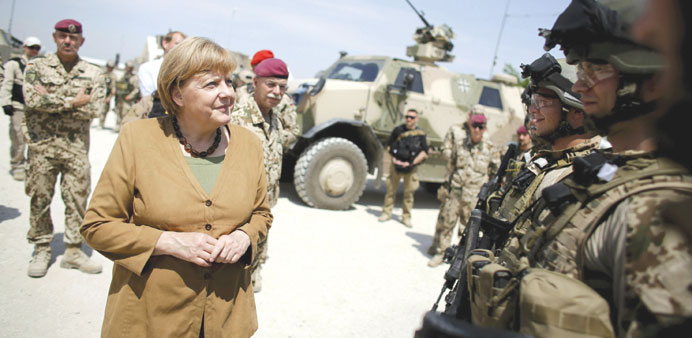German Chancellor Angela Merkel meets with soldiers as she visits a German army Bundeswehr base in Kunduz yesterday.