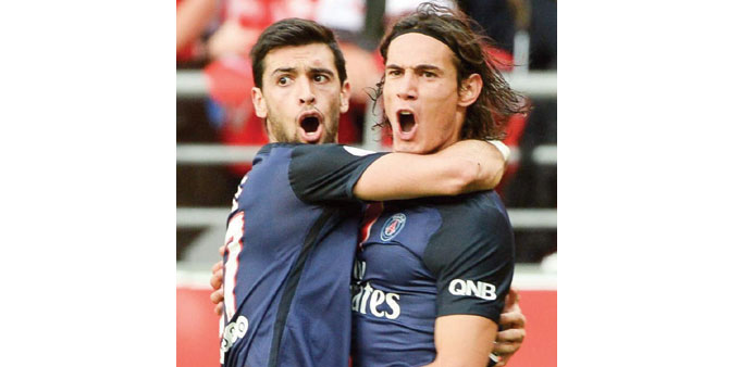 Paris Saint-Germainu2019s Edinson Cavani (right) celebrates after scoring against Reims. (AFP) 