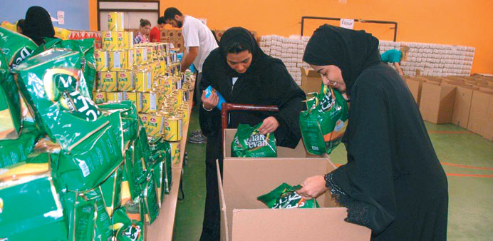 A group of volunteers packing groceries.