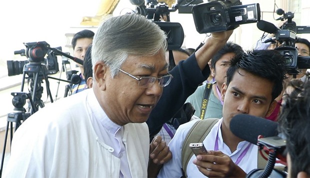 Htin Kyaw (C) talks with media in Myanmar