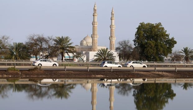 The reflection of a mosque is seen on a flooded area on the road between Dubai and Abu Dhabi on Thursday, a day after a heavy rain storm hit the Gulf state, causing flights to be suspended and flooding roads.