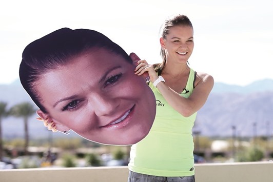 Agnieszka Radwanska holds an oversize likeness of her face at the WTA All-Access Hour during the BNP Paribas Open in Indian Wells. (Getty Images/AFP)