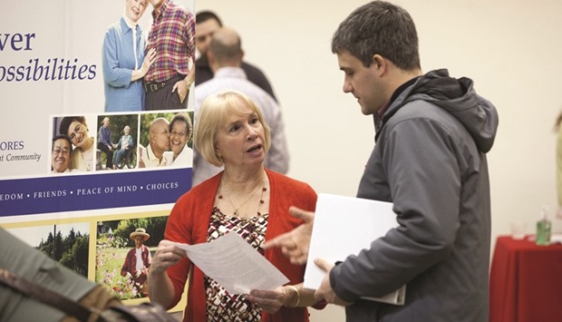 A job seeker (right) speaks with a company representative during a Choice Career Fair event in Seattle. Initial claims for state unemployment benefits declined 18,000 to a seasonally adjusted 259,000 for the week ended March 5, the lowest reading since mid-October, the US Labour Department said yesterday.