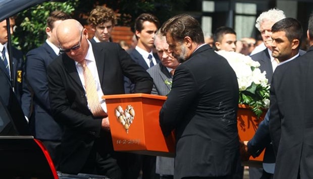 Pallbearers including actor Russell Crowe carry the casket at the funeral for Martin Crowe at the Holy Trinity Cathedral in Auckland.