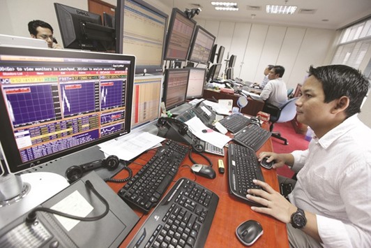 A trader looking at his computer screen as he keeps an eye on stock prices at a securities brokerage in Jakarta. The Jakarta Composite Index is on the brink of climbing out of a bear market, rising 17% from its September low.