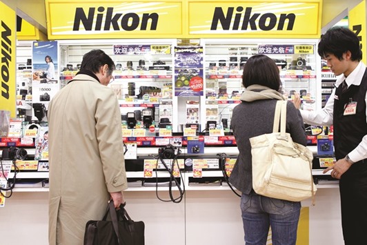 Customers browse Nikon cameras at a store in Tokyo. Nikon is the most-targeted stock with 16% of its outstanding shares being shorted as of March 9.